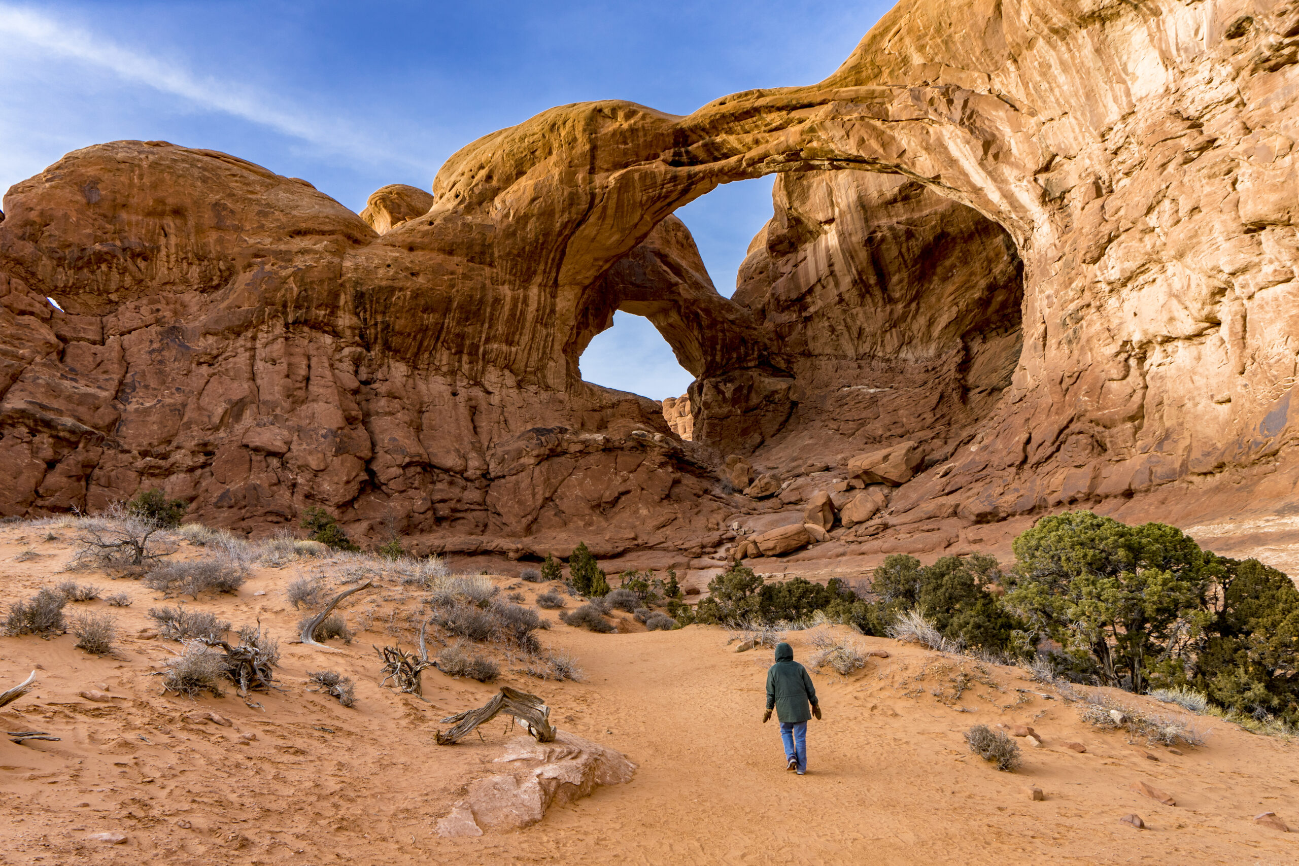 a visitor approaching the double arch