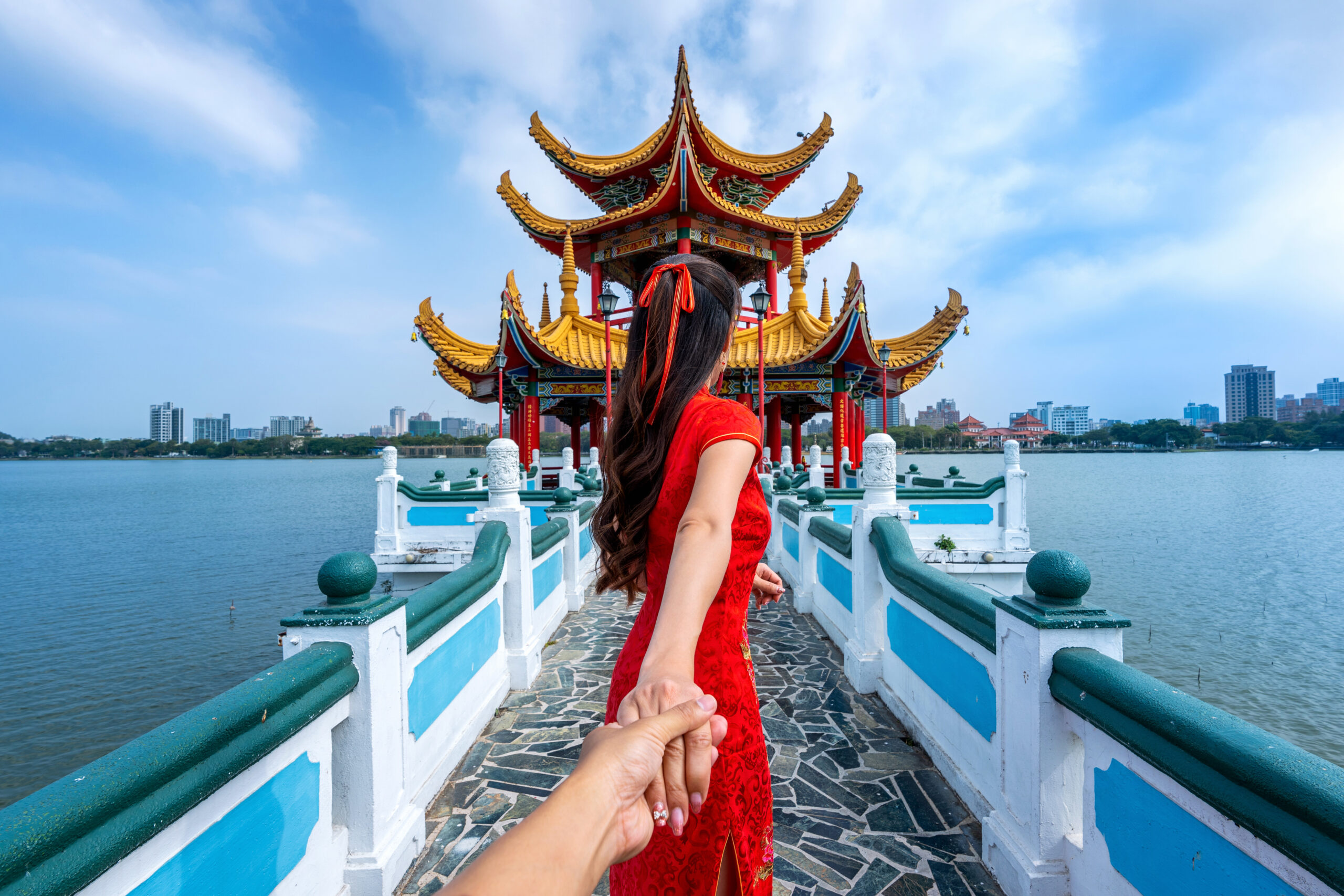 women tourists holding man's hand and leading him to kaohsiung's